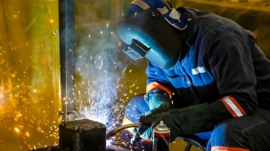 A male working with a welding torch