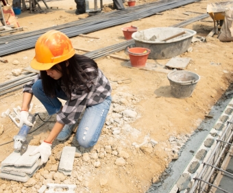 Round saw in the hands of the Builder, work on laying paving slabs. Working saws, cuts paving slab