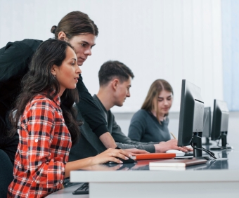 Am I doing it right. Group of young people in casual clothes working in the modern office.