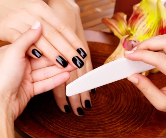Manicurist master  makes manicure on woman's hands - Spa treatment concept