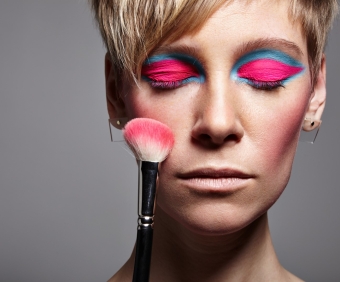 closed eyes woman with a bright cheek brush