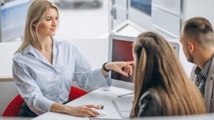 Young family buying a car at a dealer