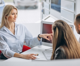 Young family buying a car at a dealer
