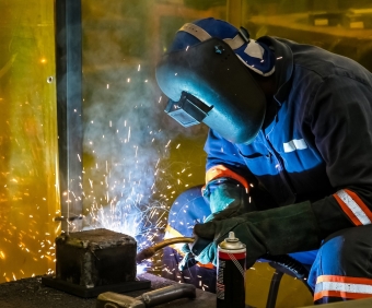 A male working with a welding torch