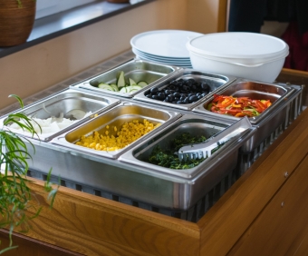 A lot of different chopped vegetable in metal containers